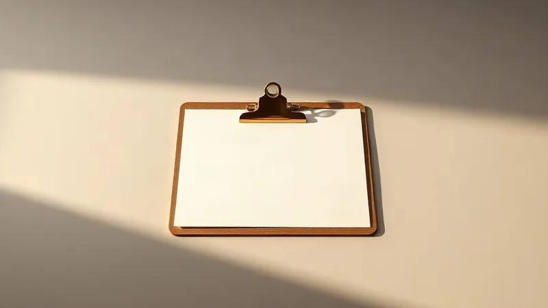 A single brass checklist clipboard rests on a plain bone coloured desk, lit from one side.