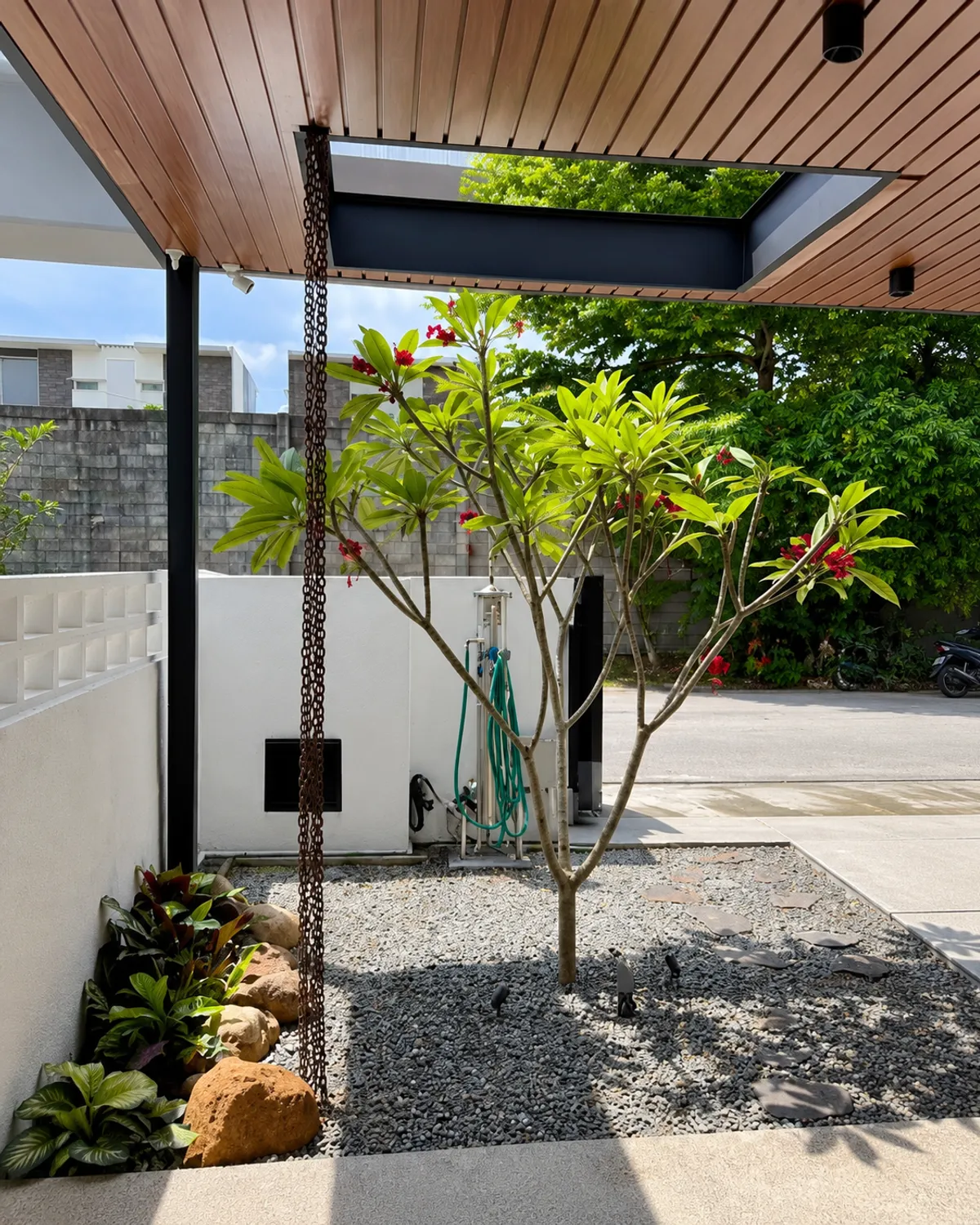 The same courtyard built and planted, shown as the after half of the comparison.