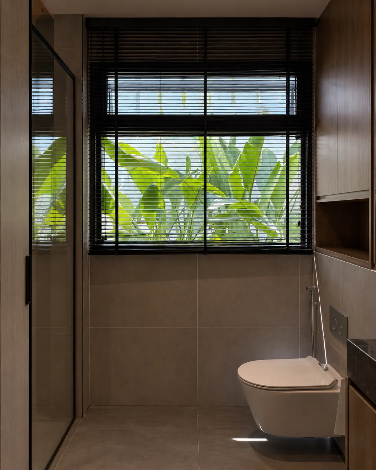 The same bathroom finished, with planting at the window.
